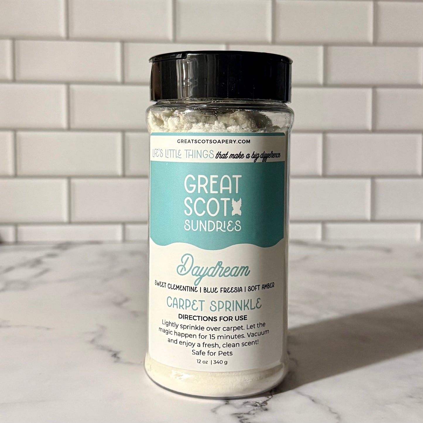 Jar of 'Great Scot Sundries' carpet sprinkle on a marble surface with a tiled wall background