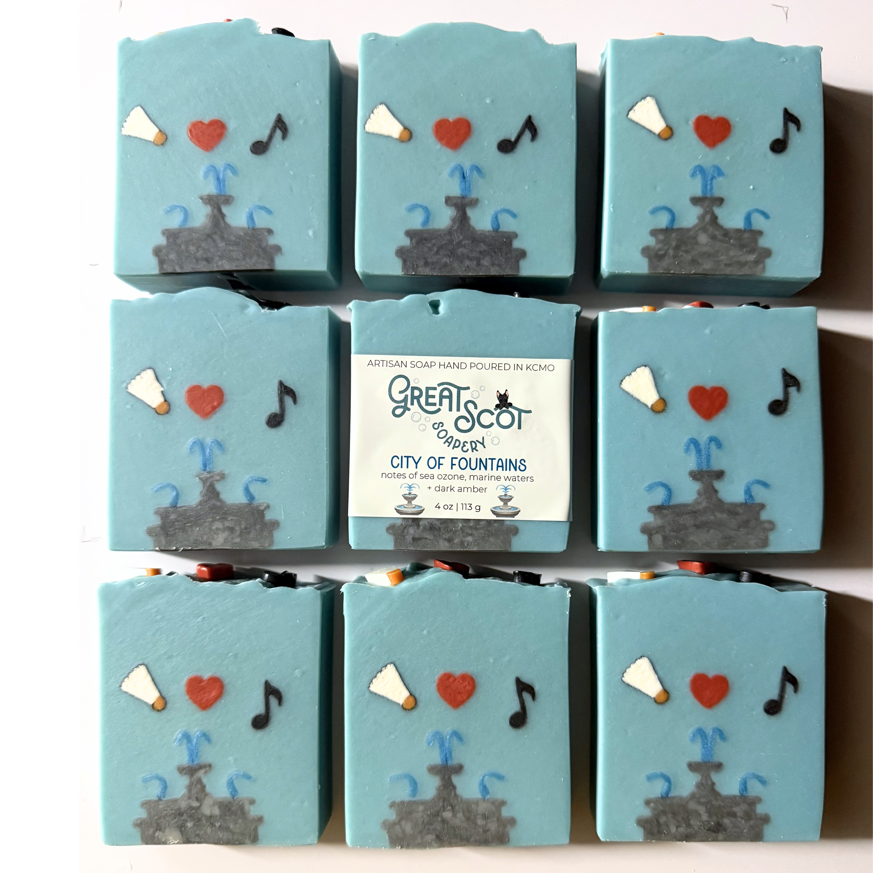 Stack of blue soap bars with decorative designs and a visible label on a white background