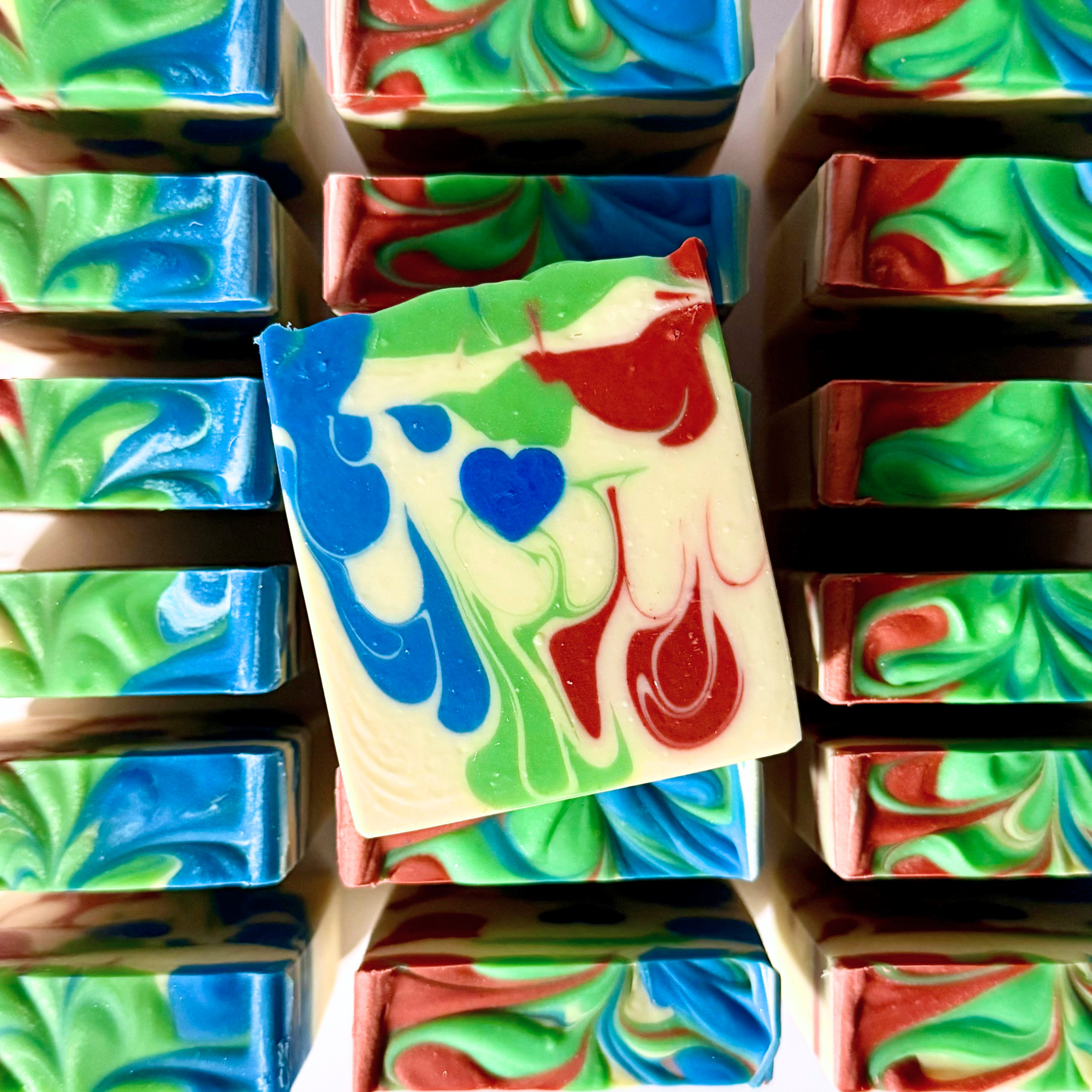 Colorful swirled soap bars arranged in a grid.