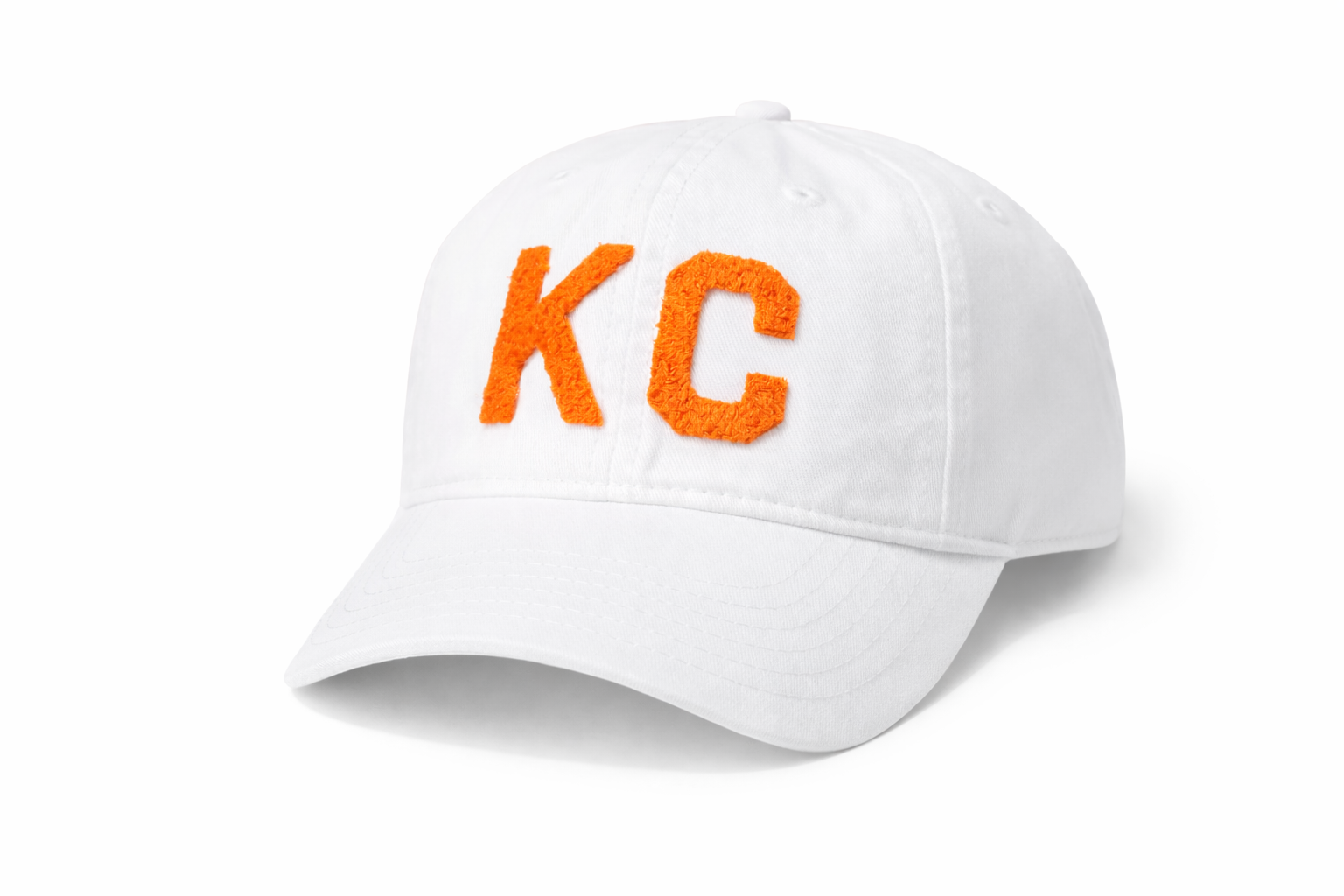 White baseball cap with 'KC' in orange on a white background