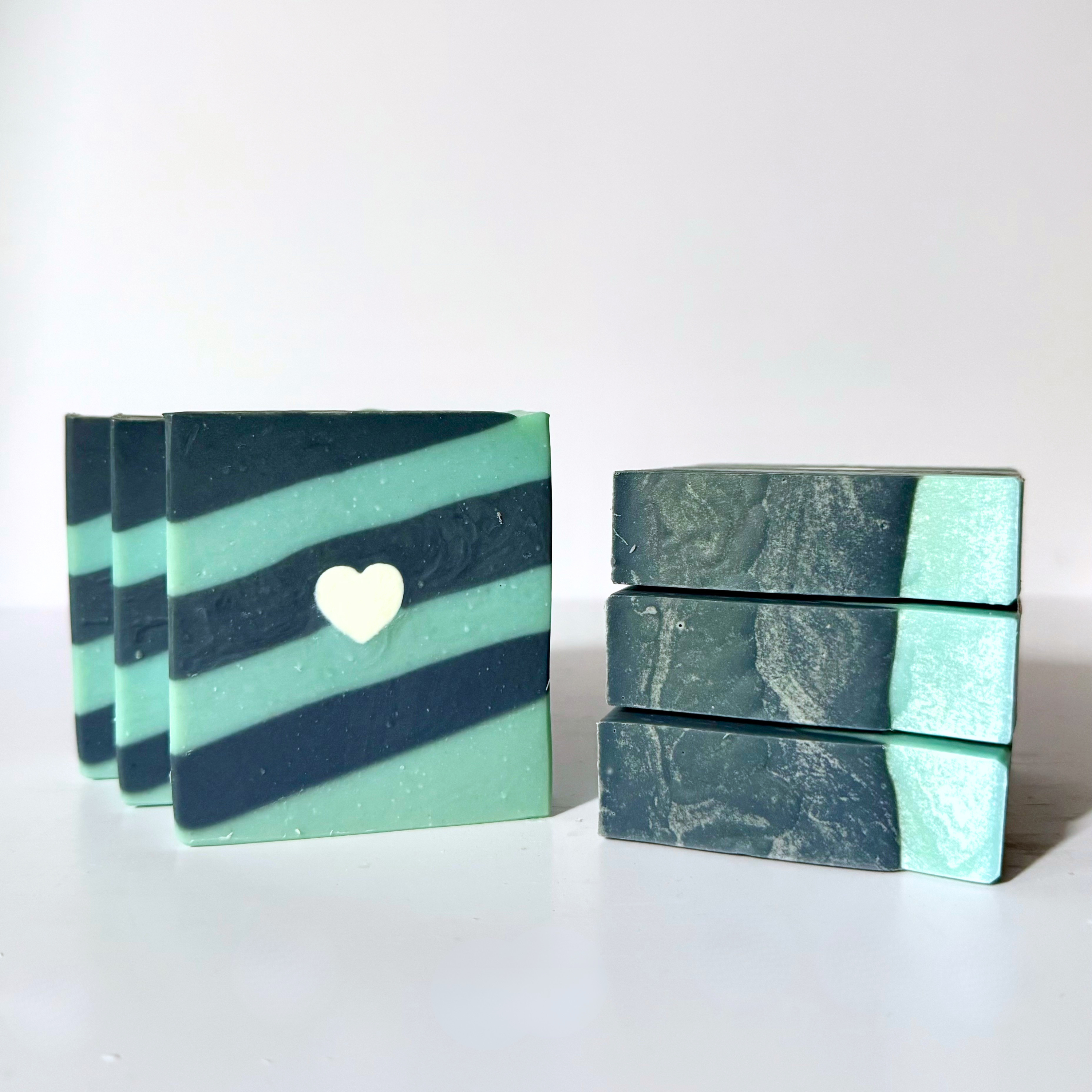 Two stacks of striped soap bars on a white background