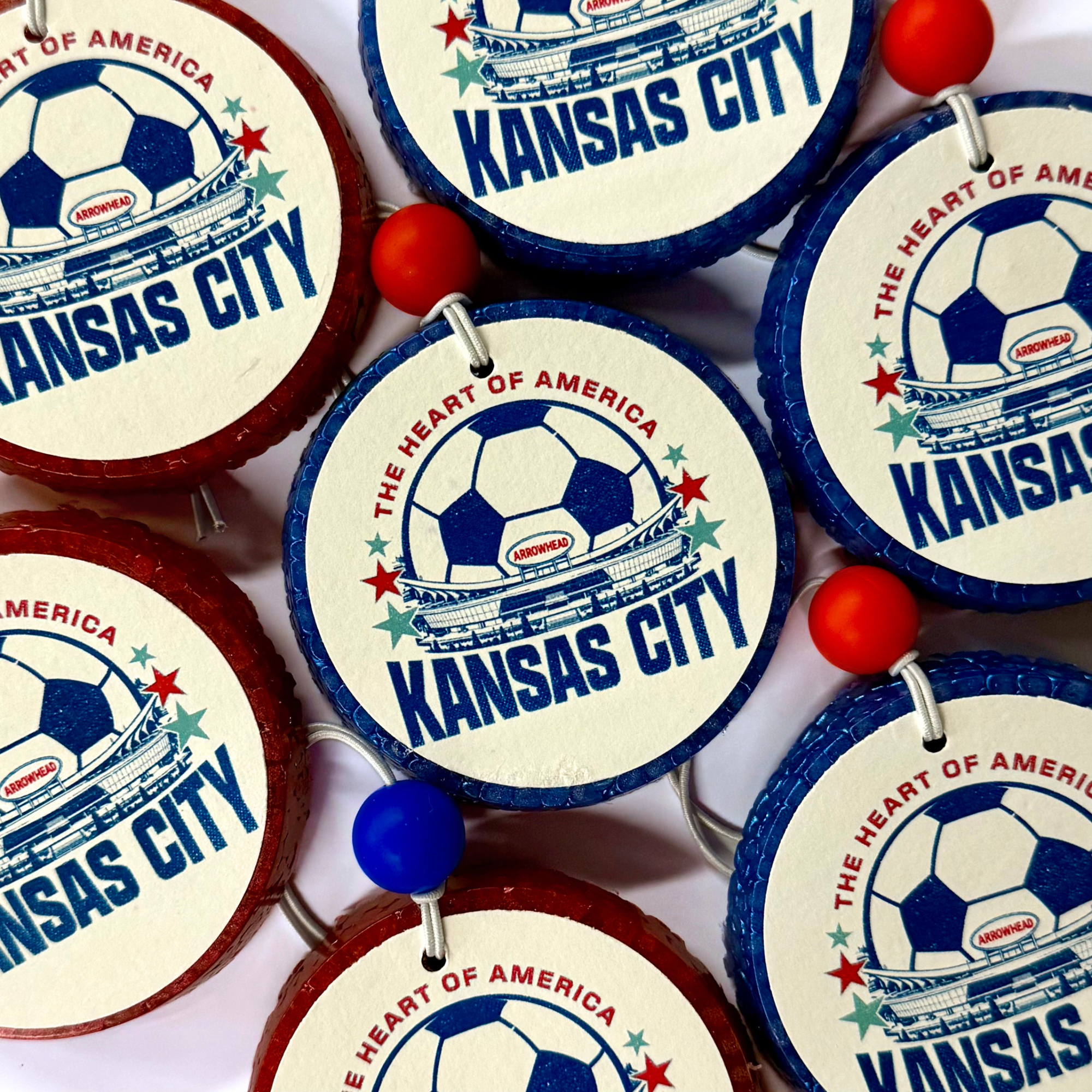 Decorative items with 'Kansas City' and soccer ball design on a white background