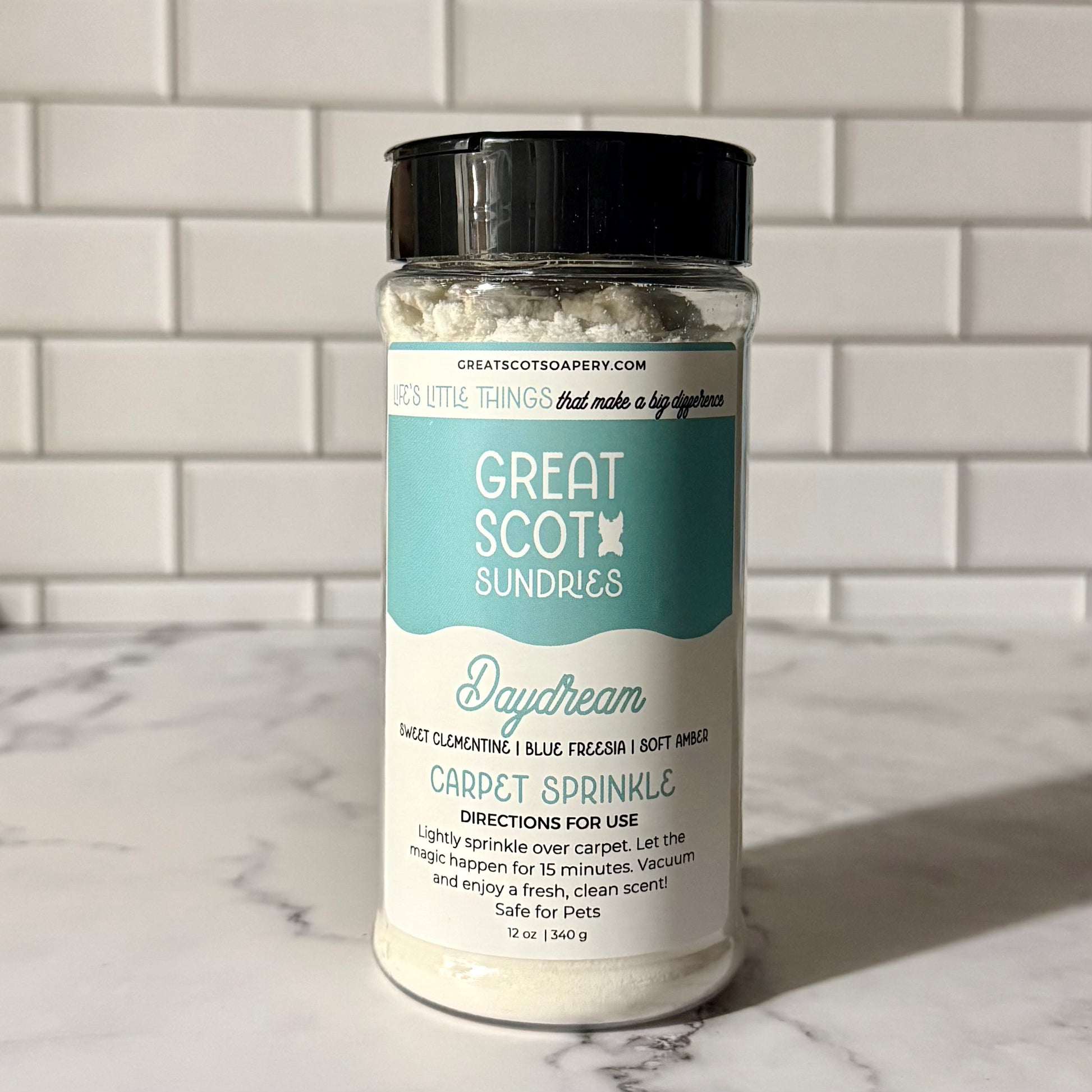 Jar of 'Great Scot Sundries' carpet sprinkle on a marble surface with a tiled wall background