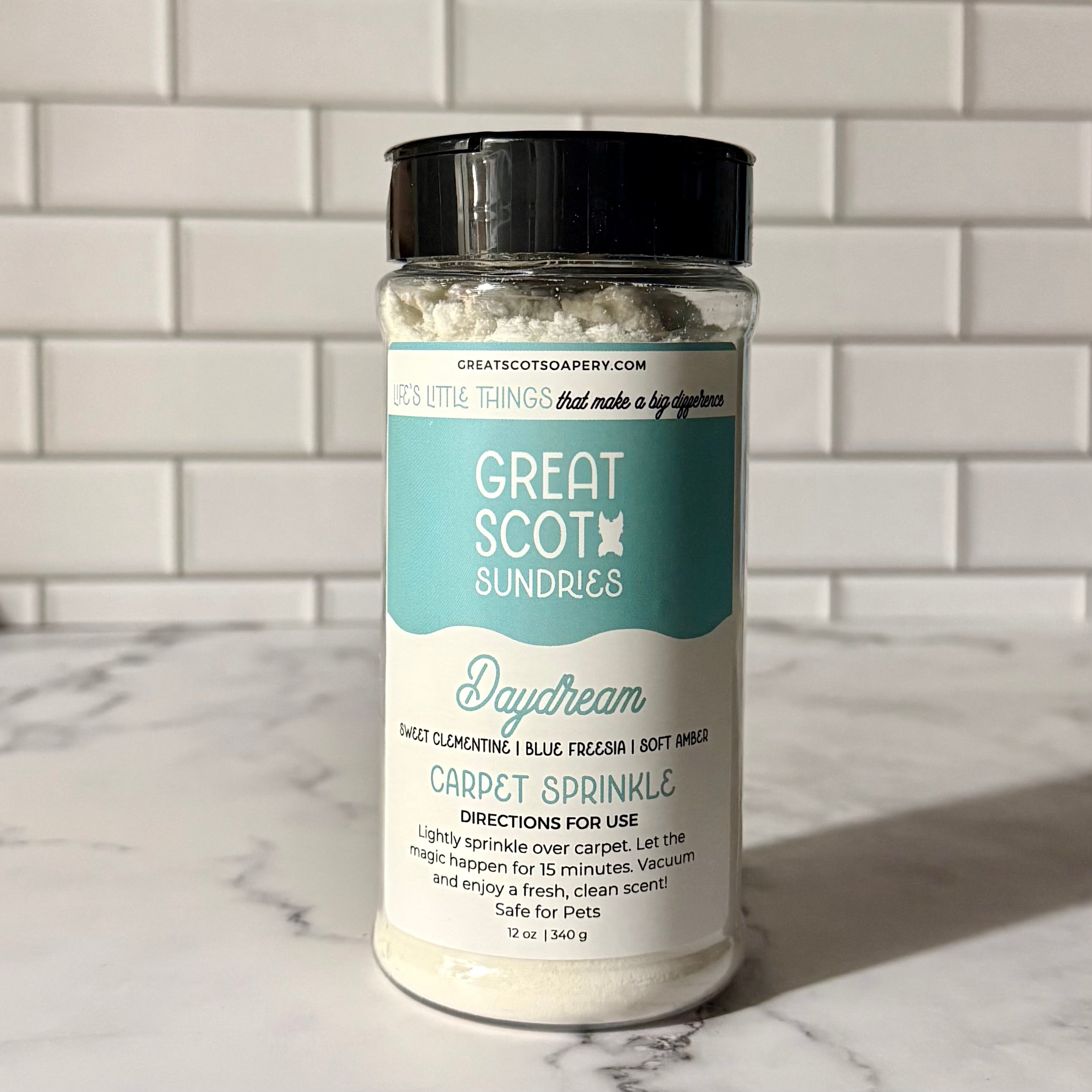 Jar of 'Great Scot Sundries' carpet sprinkle on a marble surface with a tiled wall background