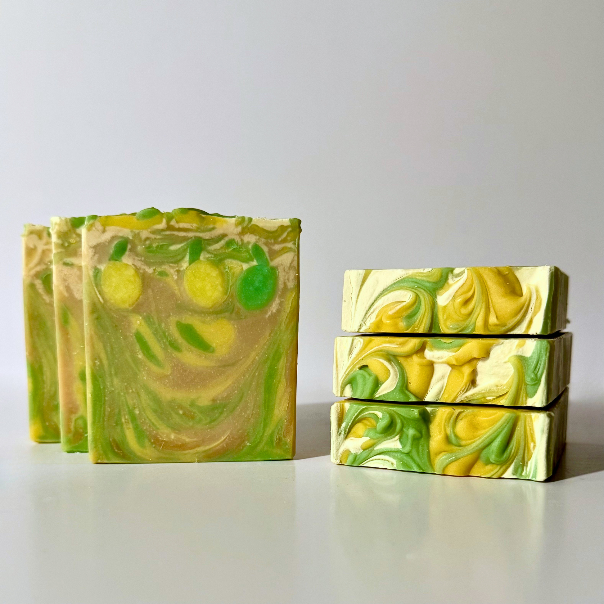Green and yellow marbled soap bars on a white background