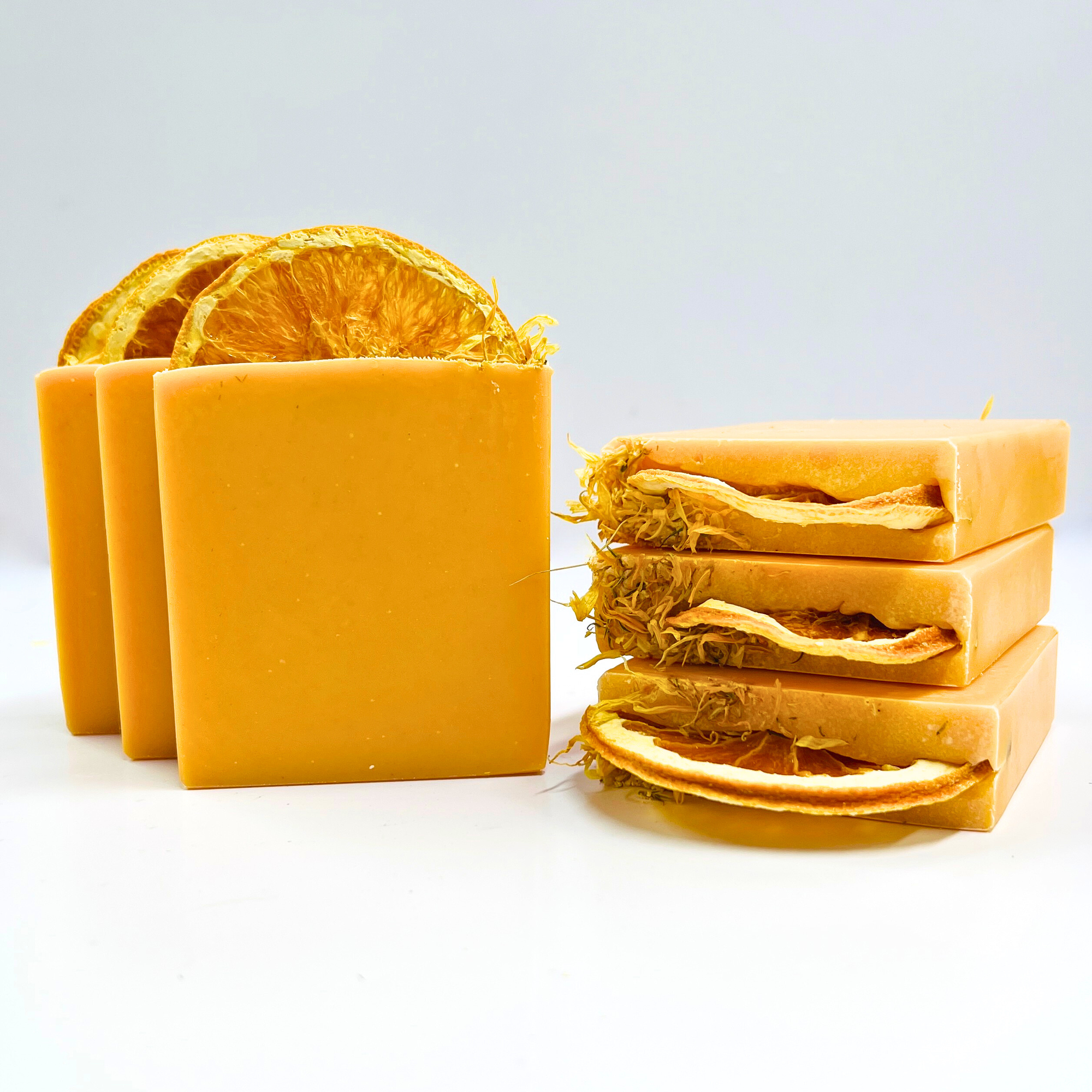 Yellow soap bars with natural elements on a white background