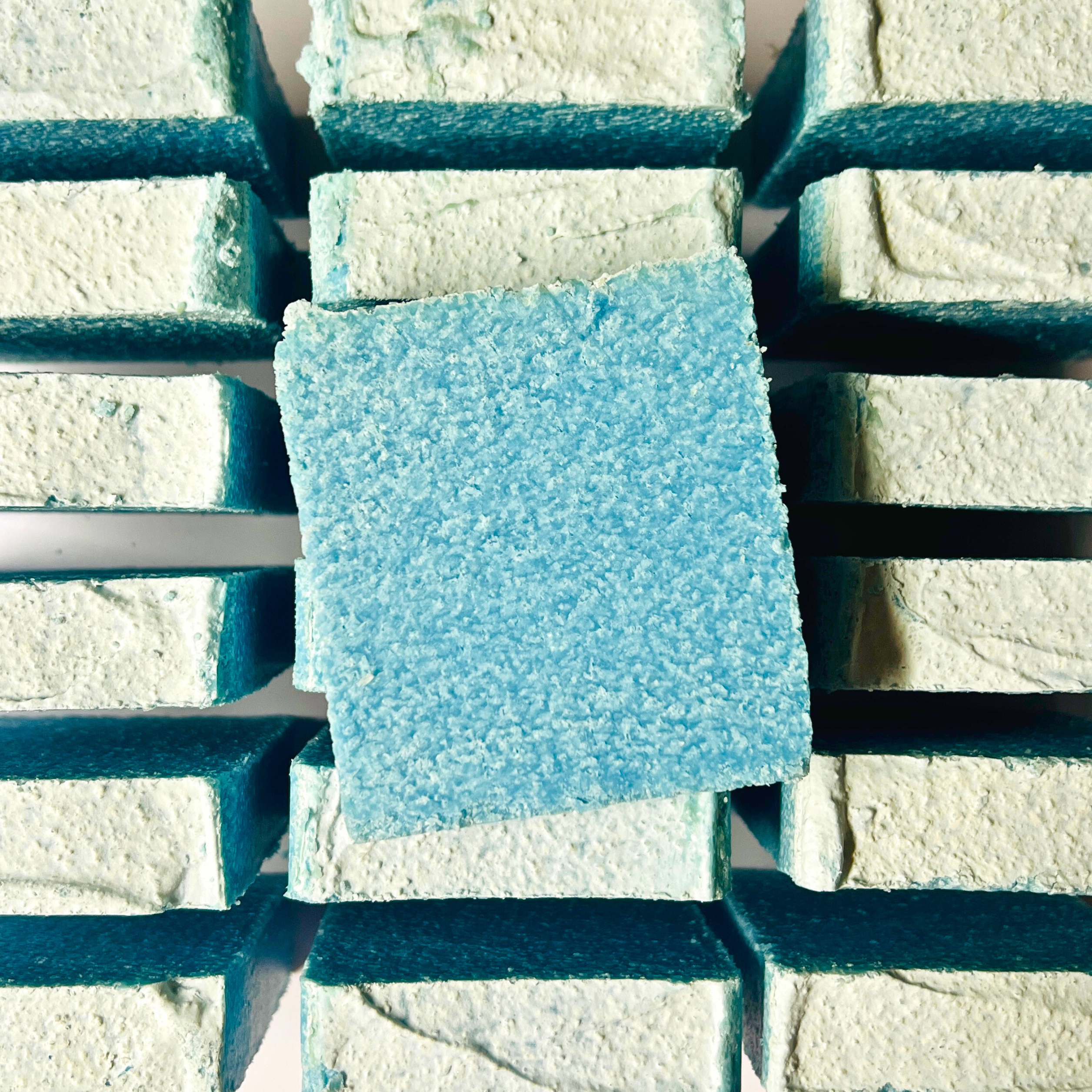 Blue and white textured soaps on a metal grate