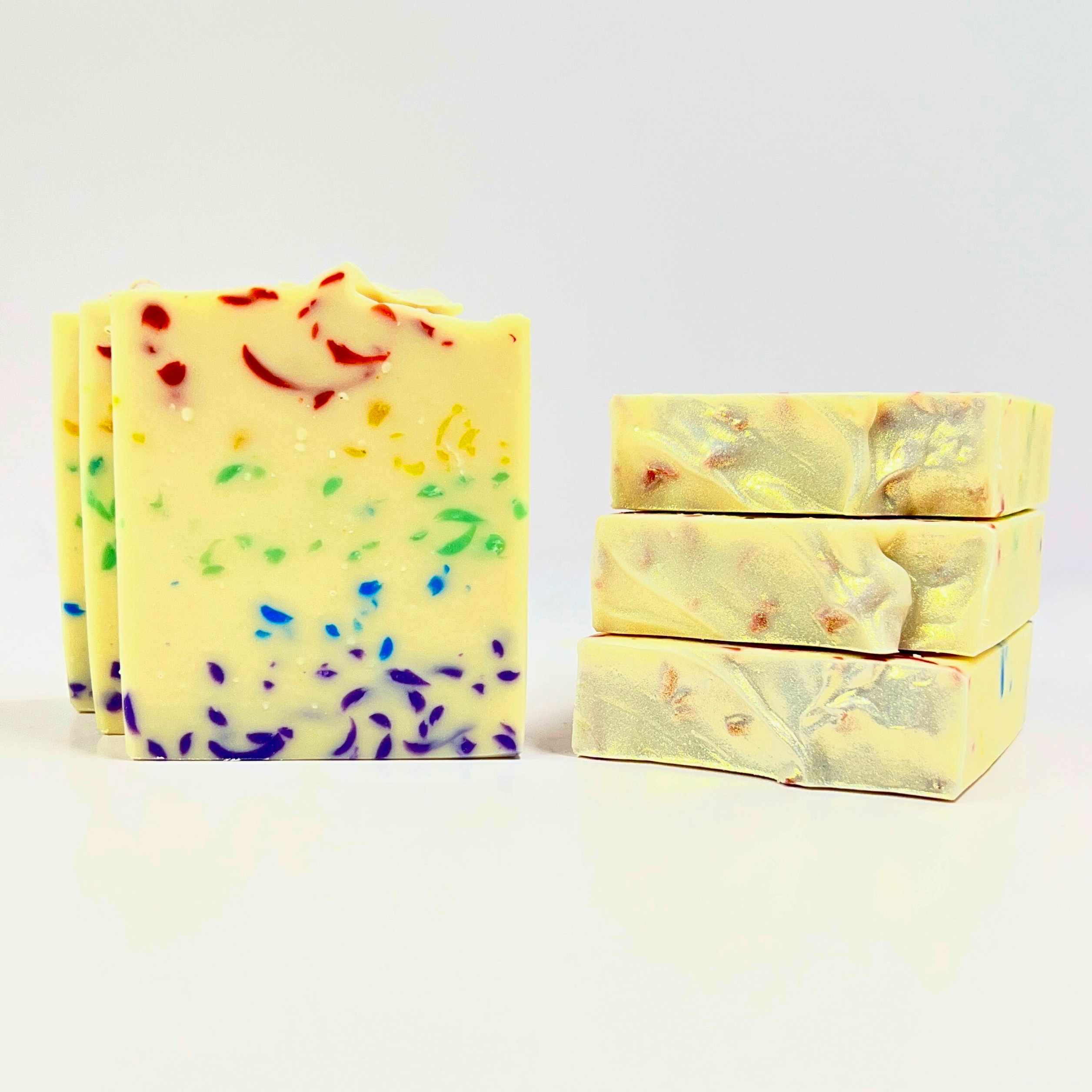 Three bars of soap with colorful swirl patterns on a white background
