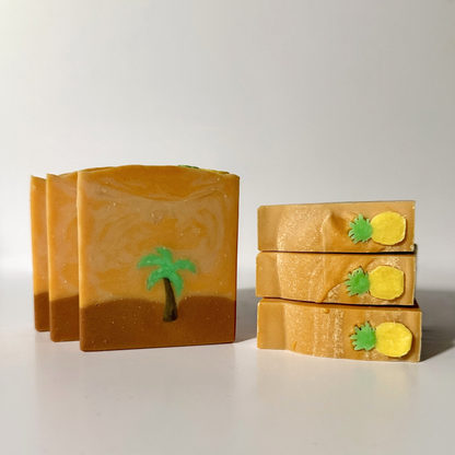 Three bars of soap with decorative elements on a light gray background